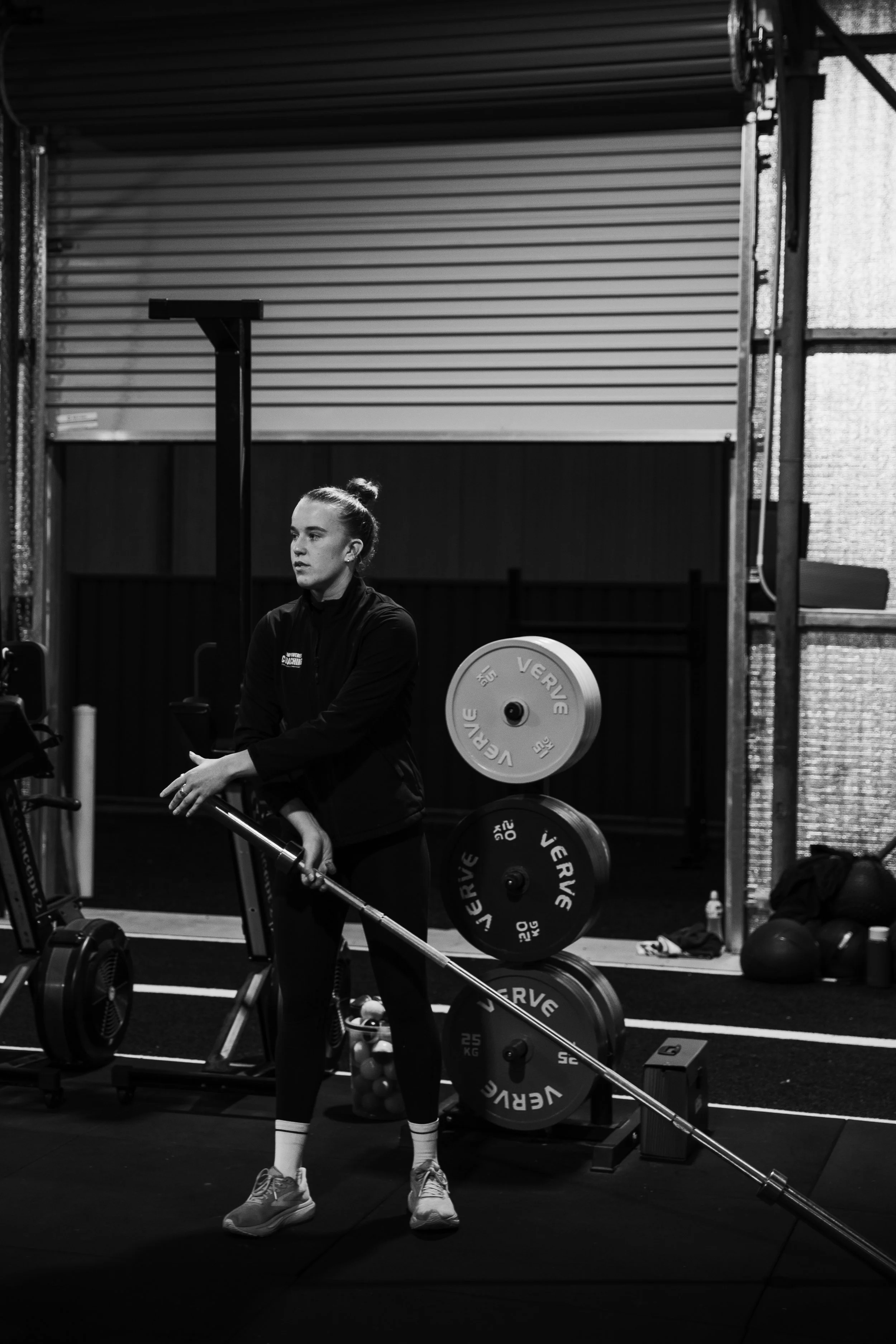 Coach Em in the gym with a barbell